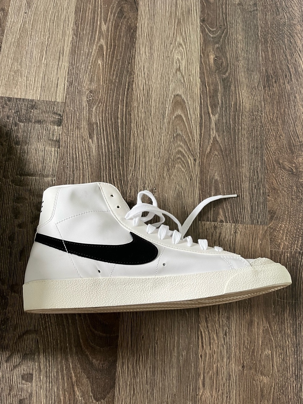 Nike White High-Top Sneaker with Black Swoosh